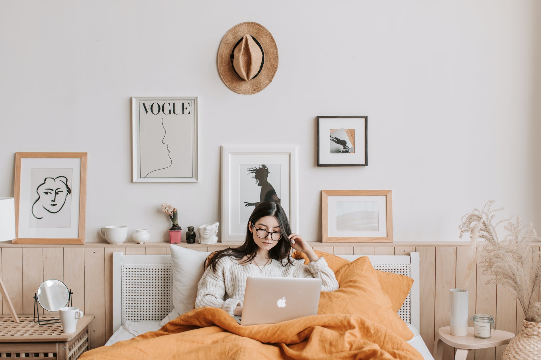 woman using laptop in bed